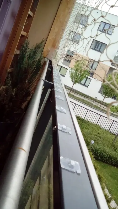Detail klipů na zábradlí balkonu — bez lepidla